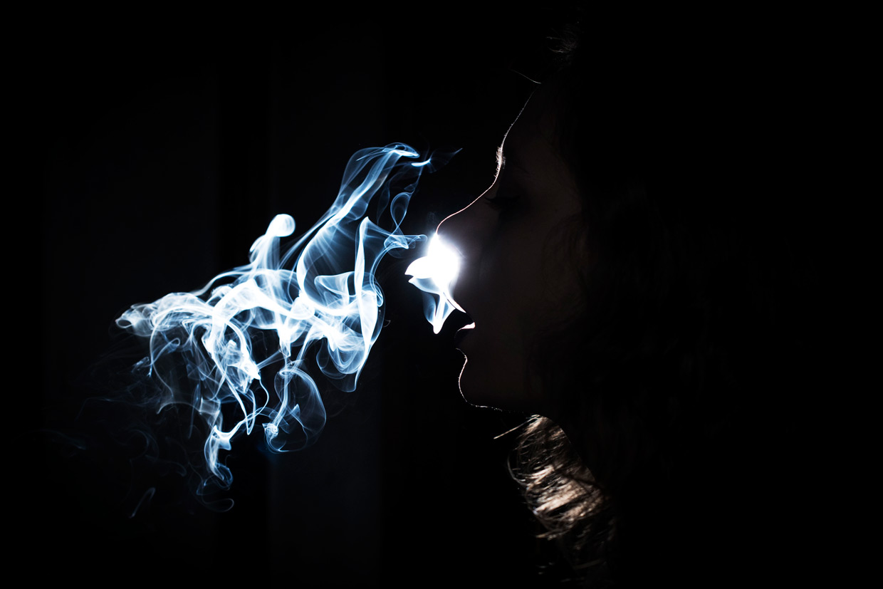 Katurah smoking, backlit photo.