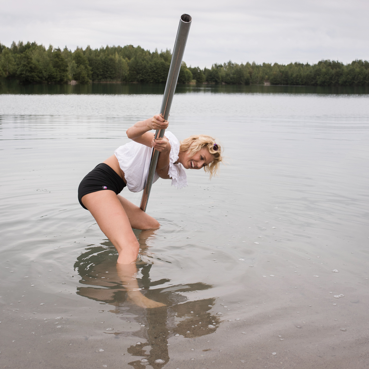 Lenita Larsson placing the pole in the water.